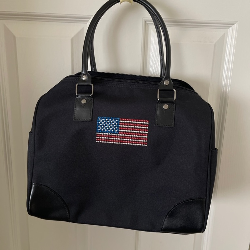 A black canvas bag embellished w/a flag